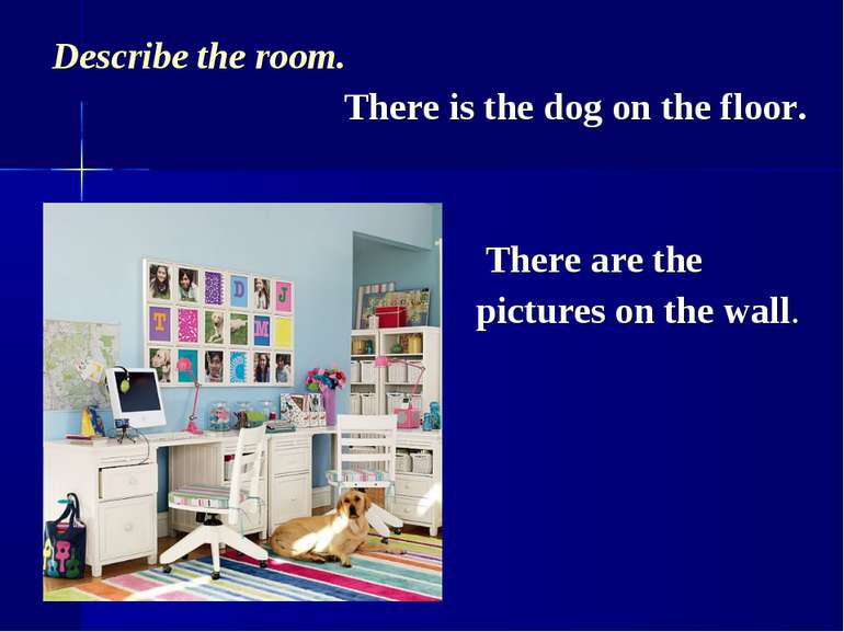 Describe the room. There is the dog on the floor. There are the pictures on t...