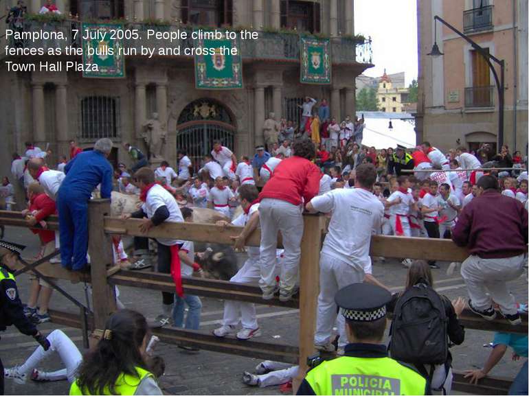 Pamplona, 7 July 2005. People climb to the fences as the bulls run by and cro...