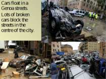Cars float in a Genoa streets. Lots of broken cars block the streets in the c...